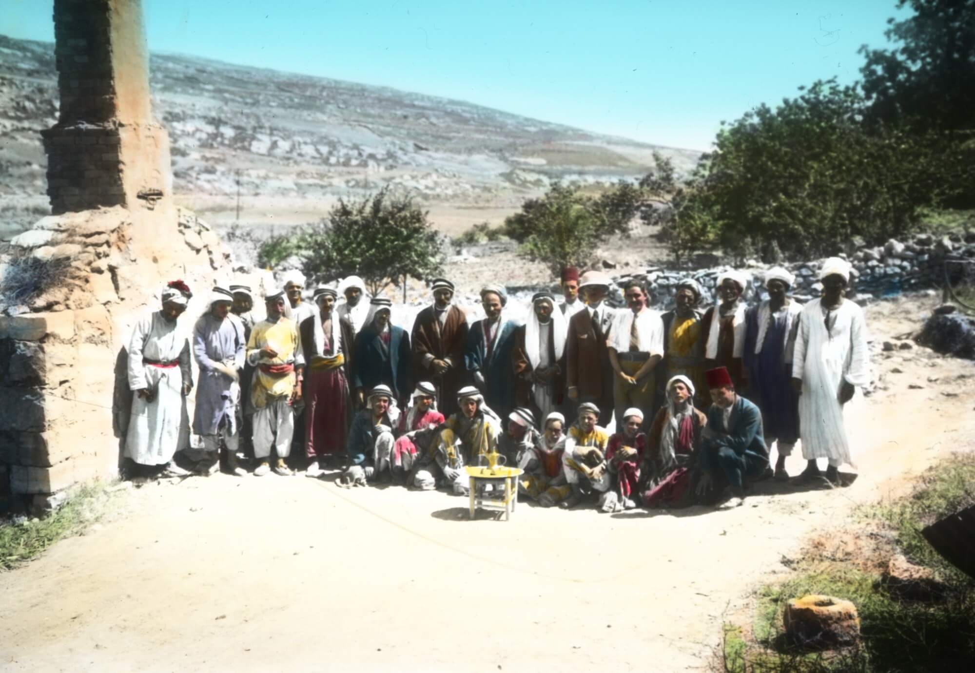 Figure 5. Expedition staff and laborers, 1926. Badè Museum photographic archive 85 N P.I. 01. Colorized lantern slide. Courtesy of the Badè Museum, Pacific School of Religion.