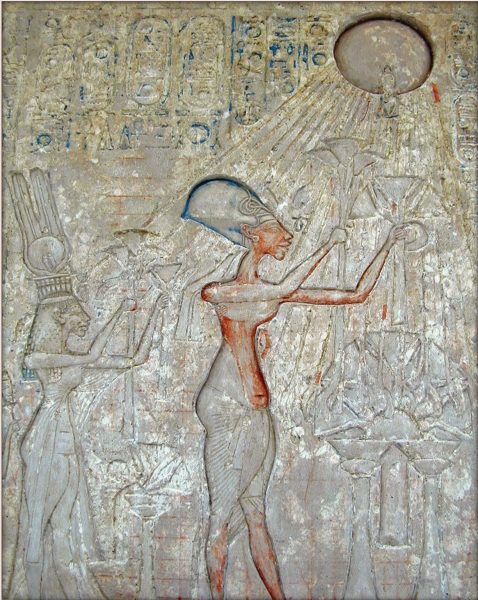 Limestone relief at Amarna Depicting Akhenaten and Nefertiti worshiping Aten. Wikimedia Commons / Jean-Pierre Dalbéra.