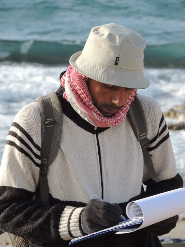 Younis, pictured here on during a survey of the coast near Leptis Magna, contributed to many field surveys in both eastern and western Libya.