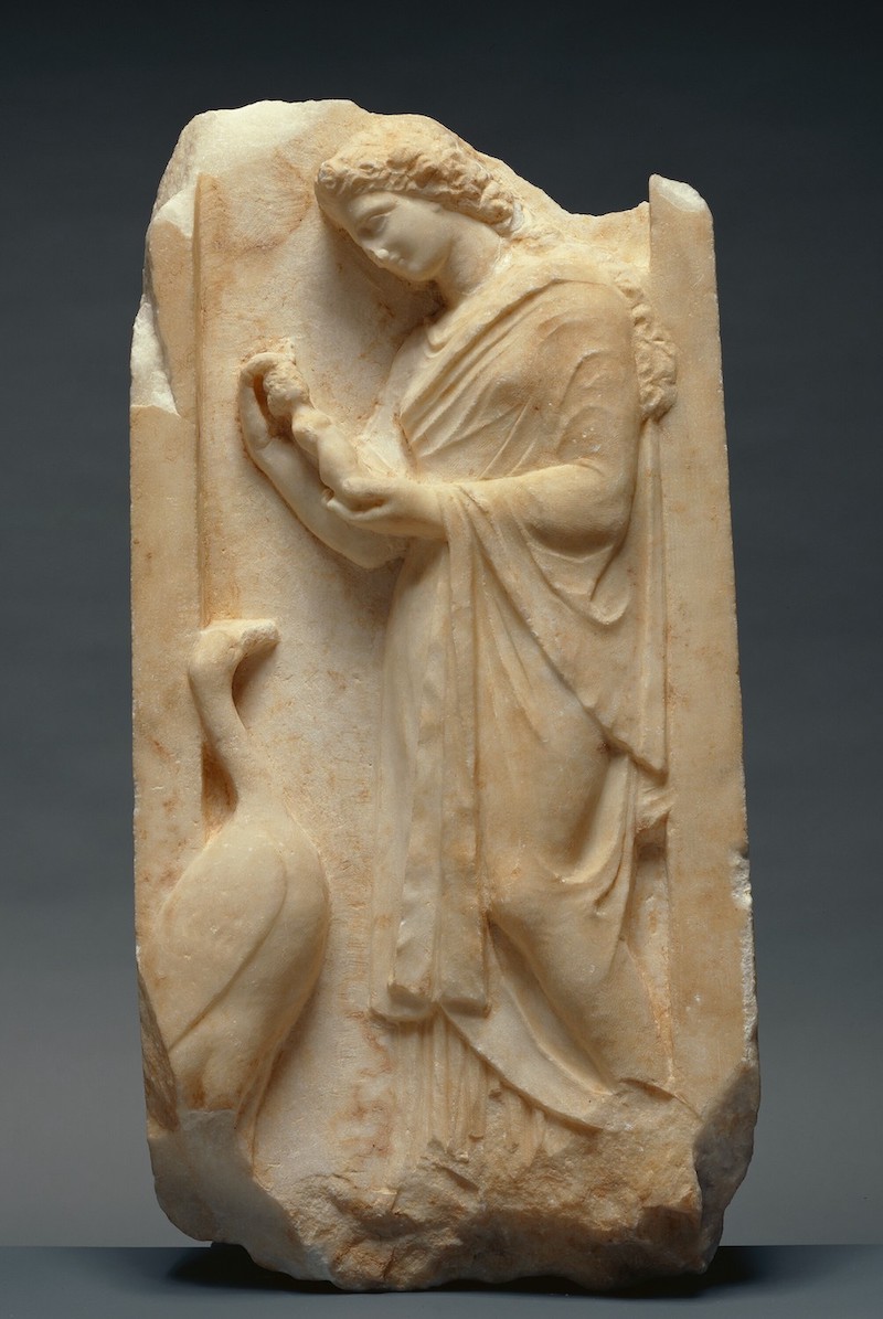 Figure 4. Grave Naiskos of a Young Woman holding a Limbless Female Figurine. Attica (Greece), marble, c. 360 BCE. Height 72.5cm. Getty 82.AA.135. Gift of Vasek Polak. Photo: Courtesy of the Getty Museum (Public Domain).