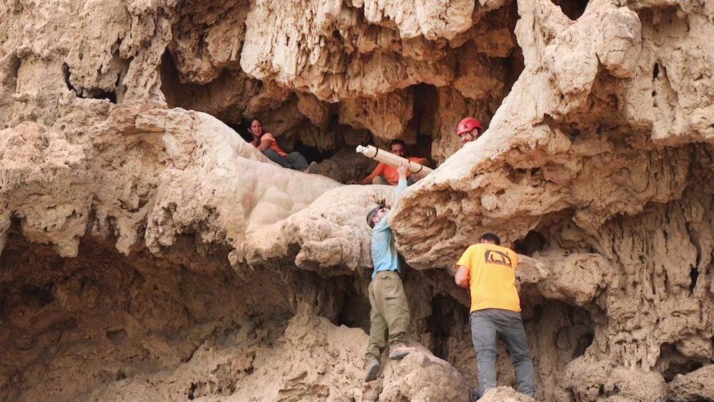 Archaeologists remove Roman swords from a cave near ‘En Gedi. Photo: Emil Aladjem, courtesy of the Israel Antiquities Authority.