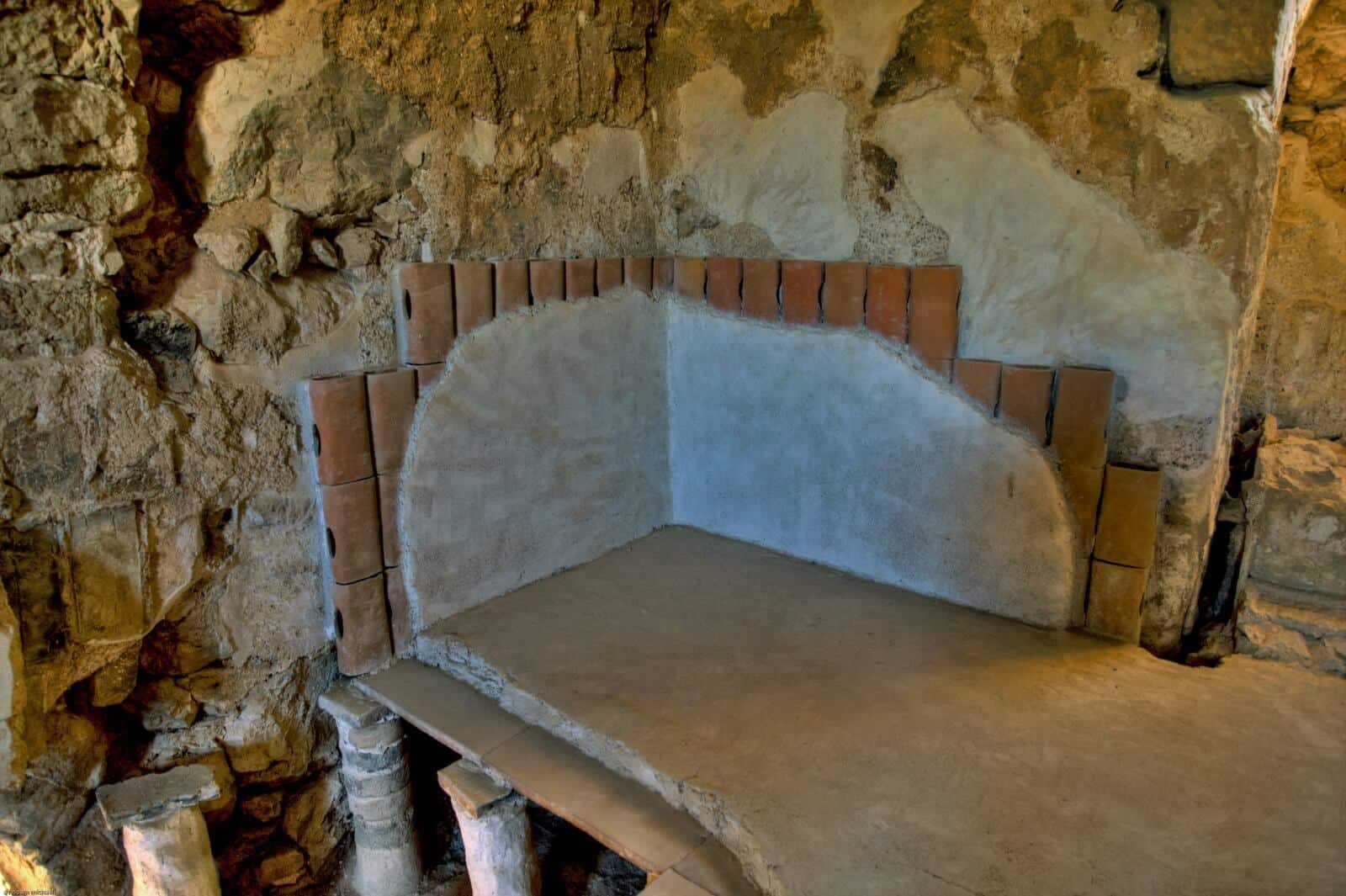 The hot room of the first century BCE bath in the palace of King Herod at Masada. Note the suspended floor as it rests on the pillars of the hypocaust system and pipes (tubuli) that circulate the hot air behind the walls. Courtesy of Guy Shtibel.