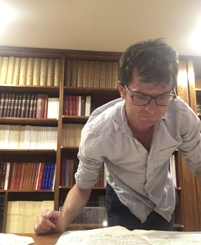 Examining one of the records related to the history of the Custody. Photo courtesy of author.
