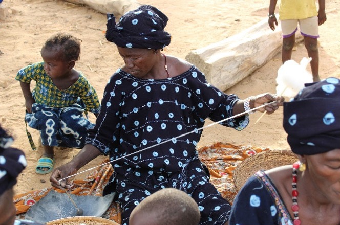 Step 3: Twisting the thread using a distaff (right) and spindle (left); Photo Credit: ADI/ASOR