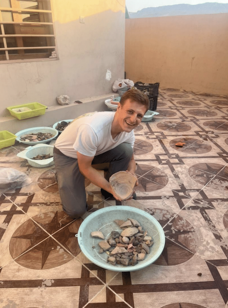Posing with one of the washed pottery baskets. After being cleaned by the Kurdish students on the project team, it was my daily task to sort through these baskets of pottery, counting each sherd and keeping those that were diagnostic.