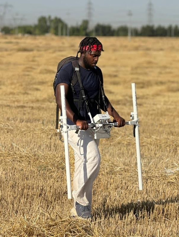 Photo of Lonnie Reid operating a magnetometer.